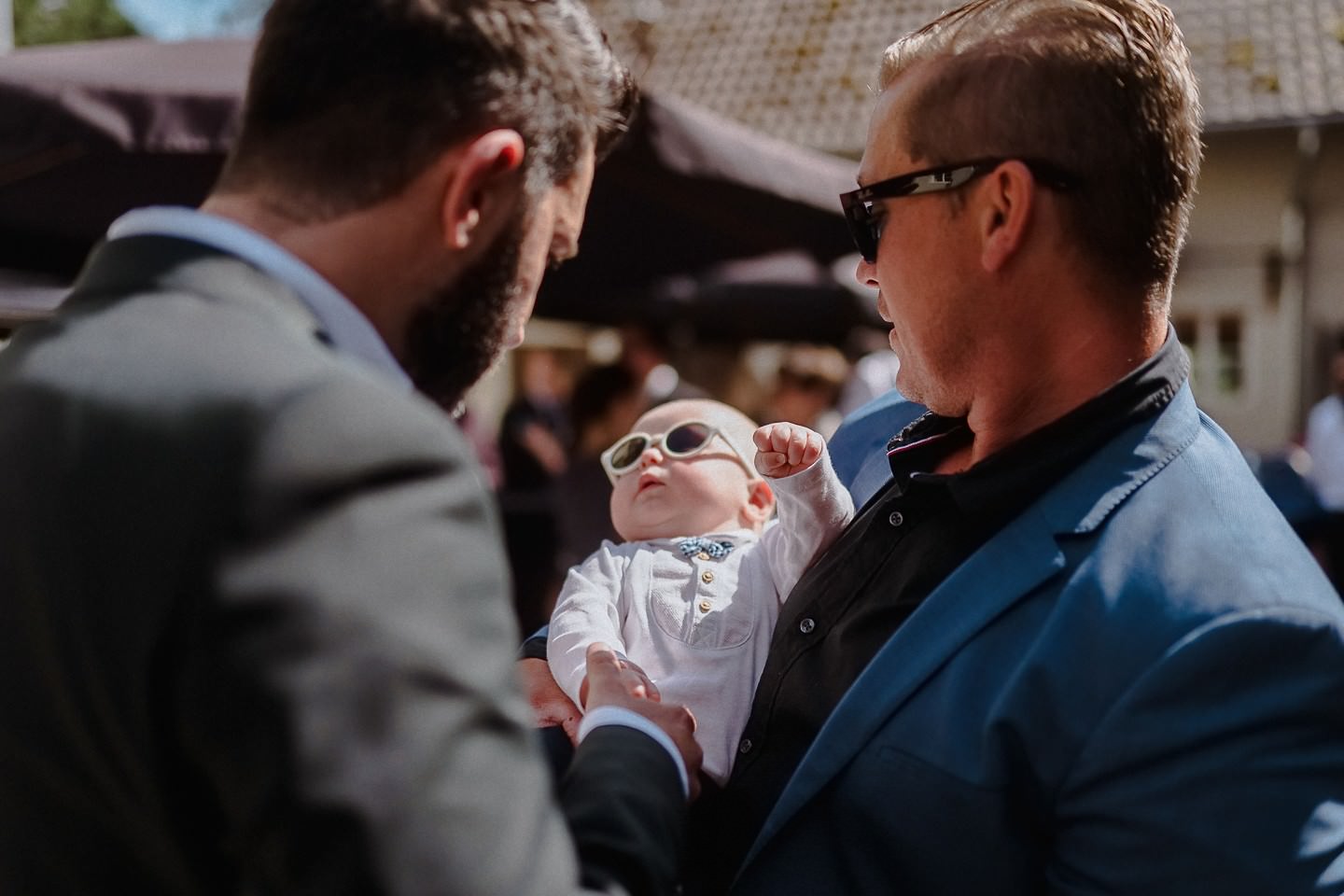 Baby mit Sonnenbrille gratuliert dem Bräutigam