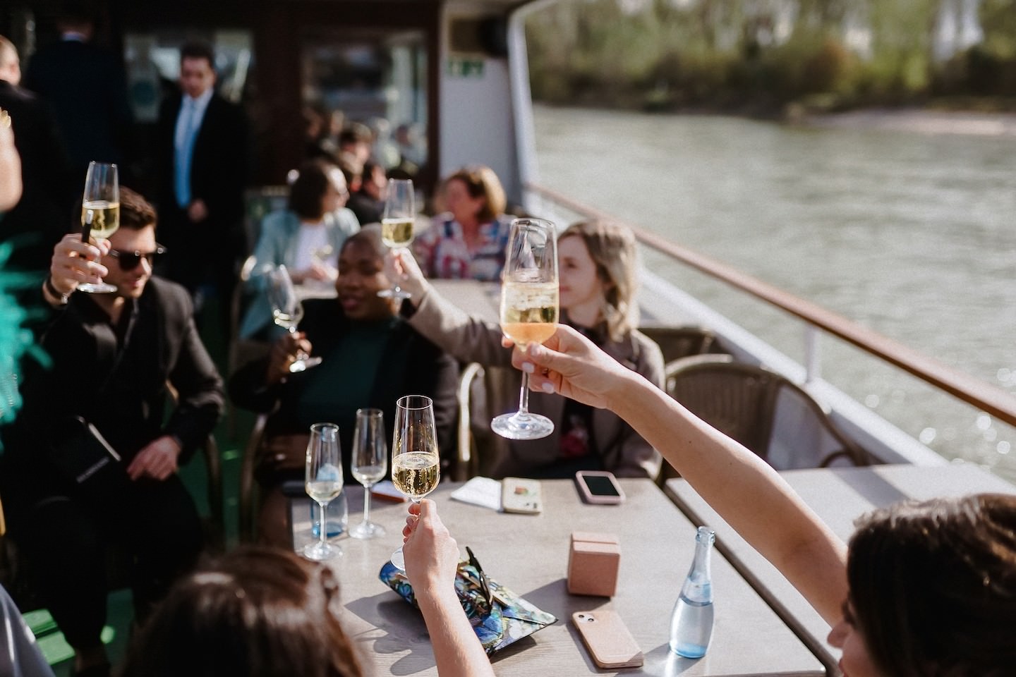 Gäste der Hochzeit prosten sich mit Sekt zu auf einem Boot auf dem Rhein