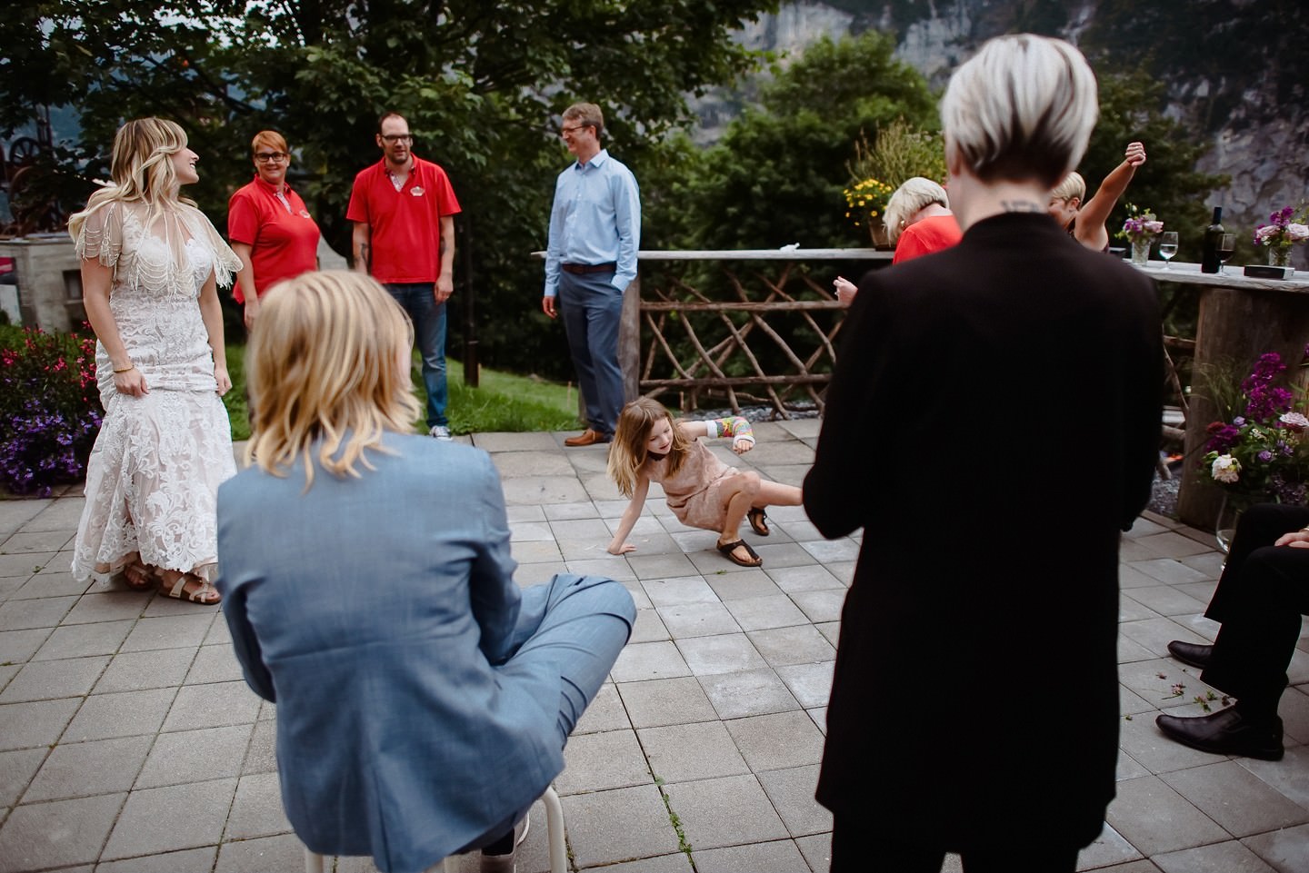 Gast macht Akrobatik vor Hochzeitsgästen, Terrasse, lustig.