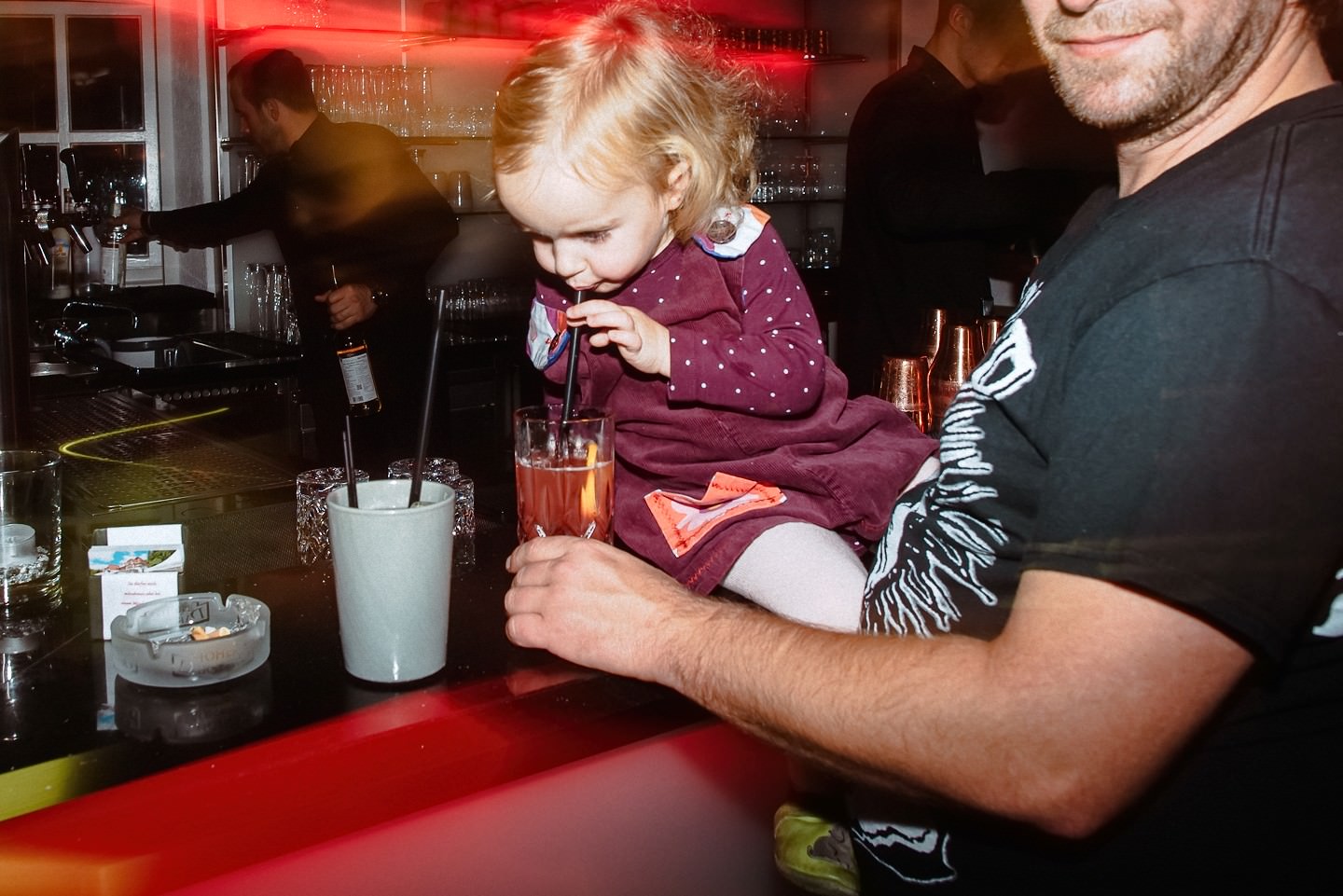 Mädchen probiert den Drink an der Bar bei der Party.