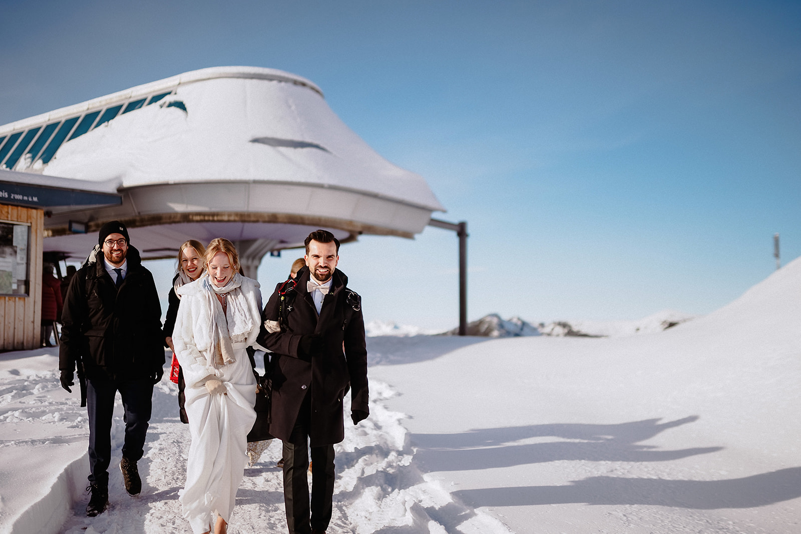 Das Brautpaar kommt lachend an der Bergstation Sareis auf 2000 Metern an